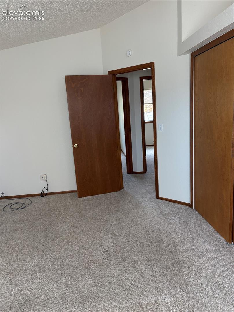 Neutral wall tones, wall-to-wall carpeting, and solid wood-finish interior doors