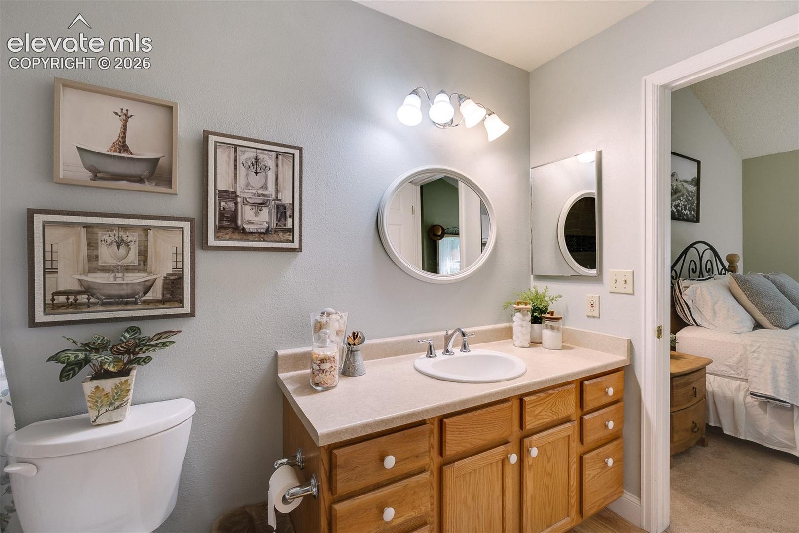The Primary Bathroom offers a vanity, mirror, and tiled tub/shower.