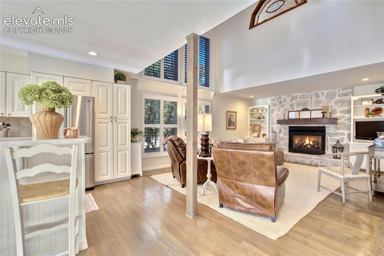 Soaring 21' ceilings give the great room an extraordinary sense of volume + light.