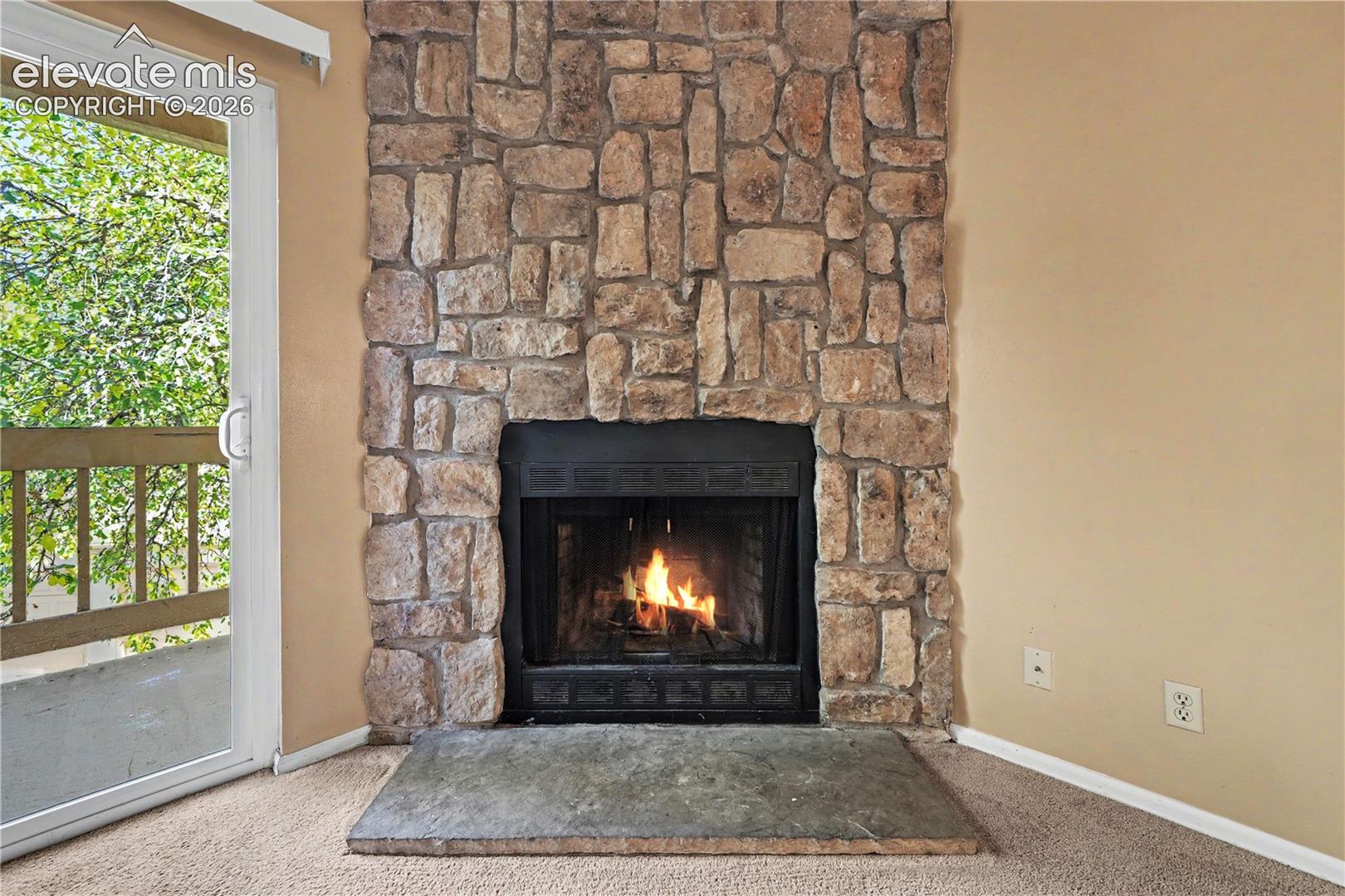 Stone surround wood burning fireplace