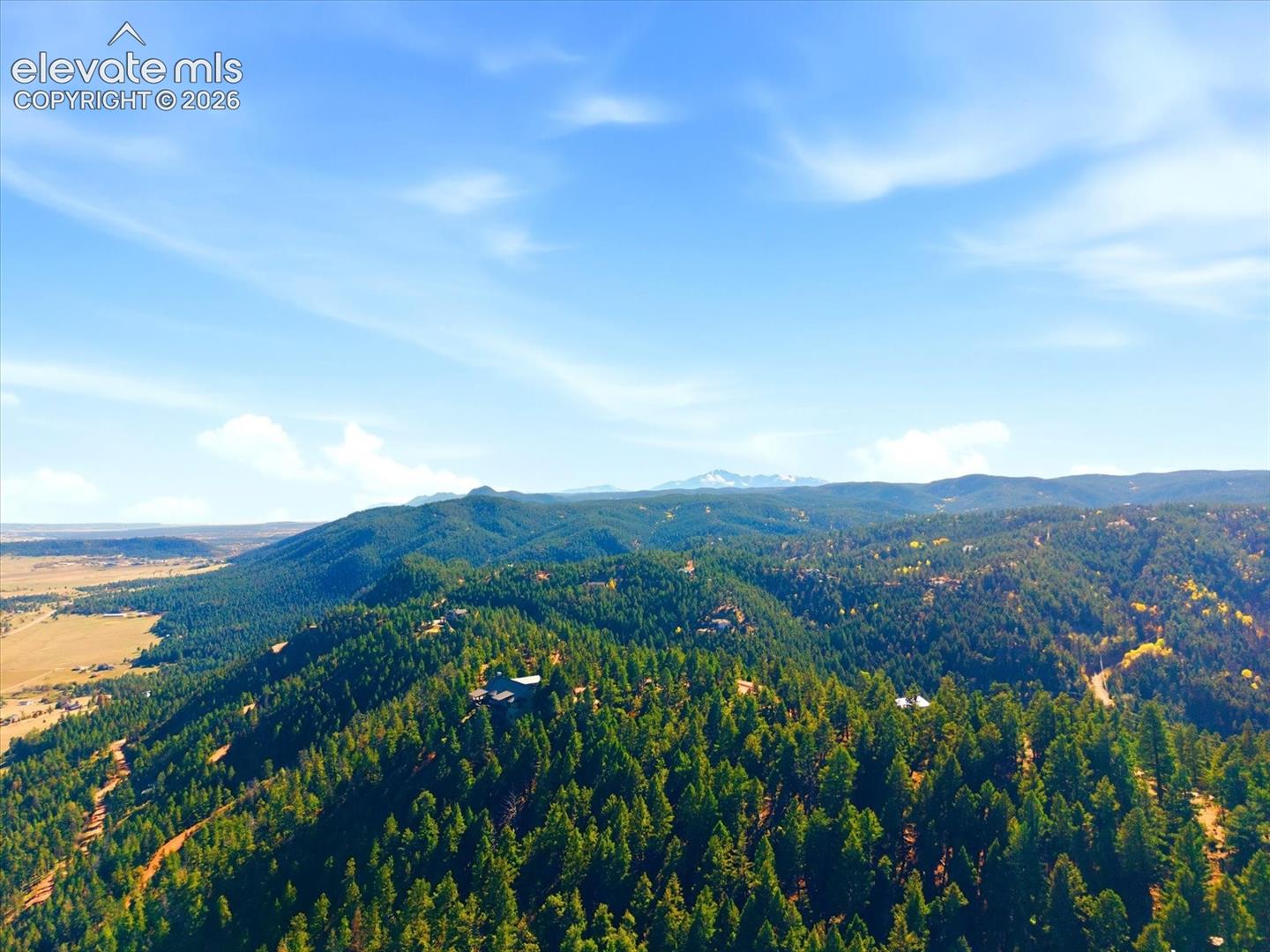 Aerial perspective featuring Pikes Peak, vast evergreen forests and rolling mountain terrain