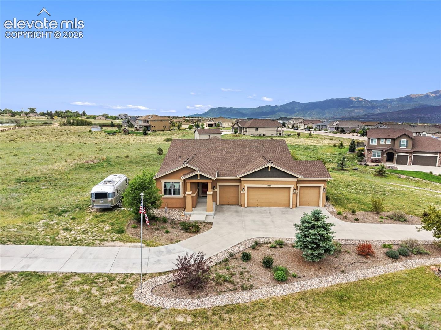 Aerial view of property with mountains as backdrop