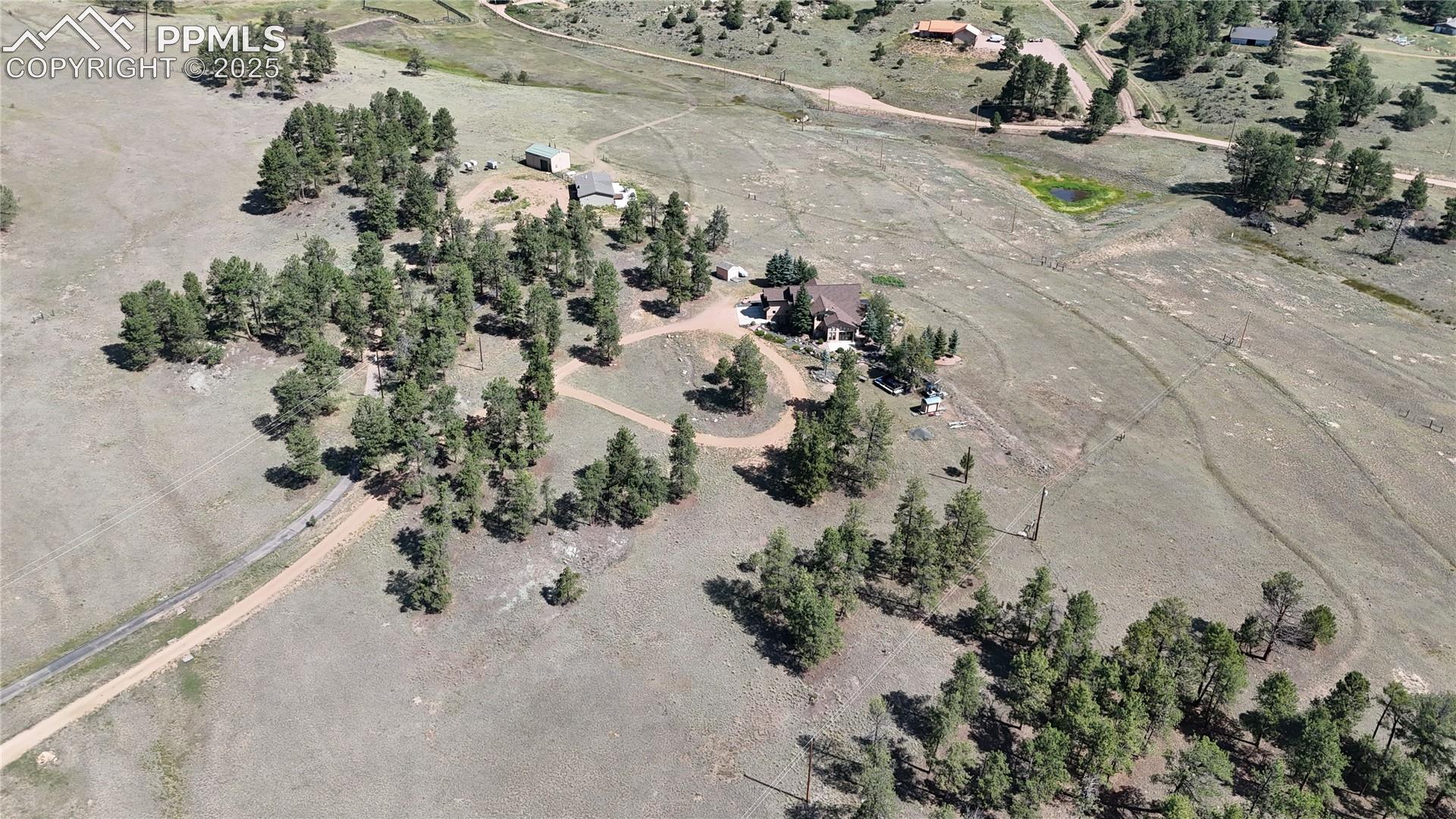 Aerial view of property and surrounding area with rural landscape