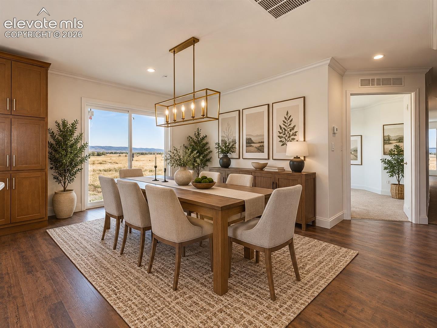 Dining Area – Spacious dining area is positioned beside the kitchen and sliding glass door, with an eye-catching contemporary light fixture and expansive views across the property.