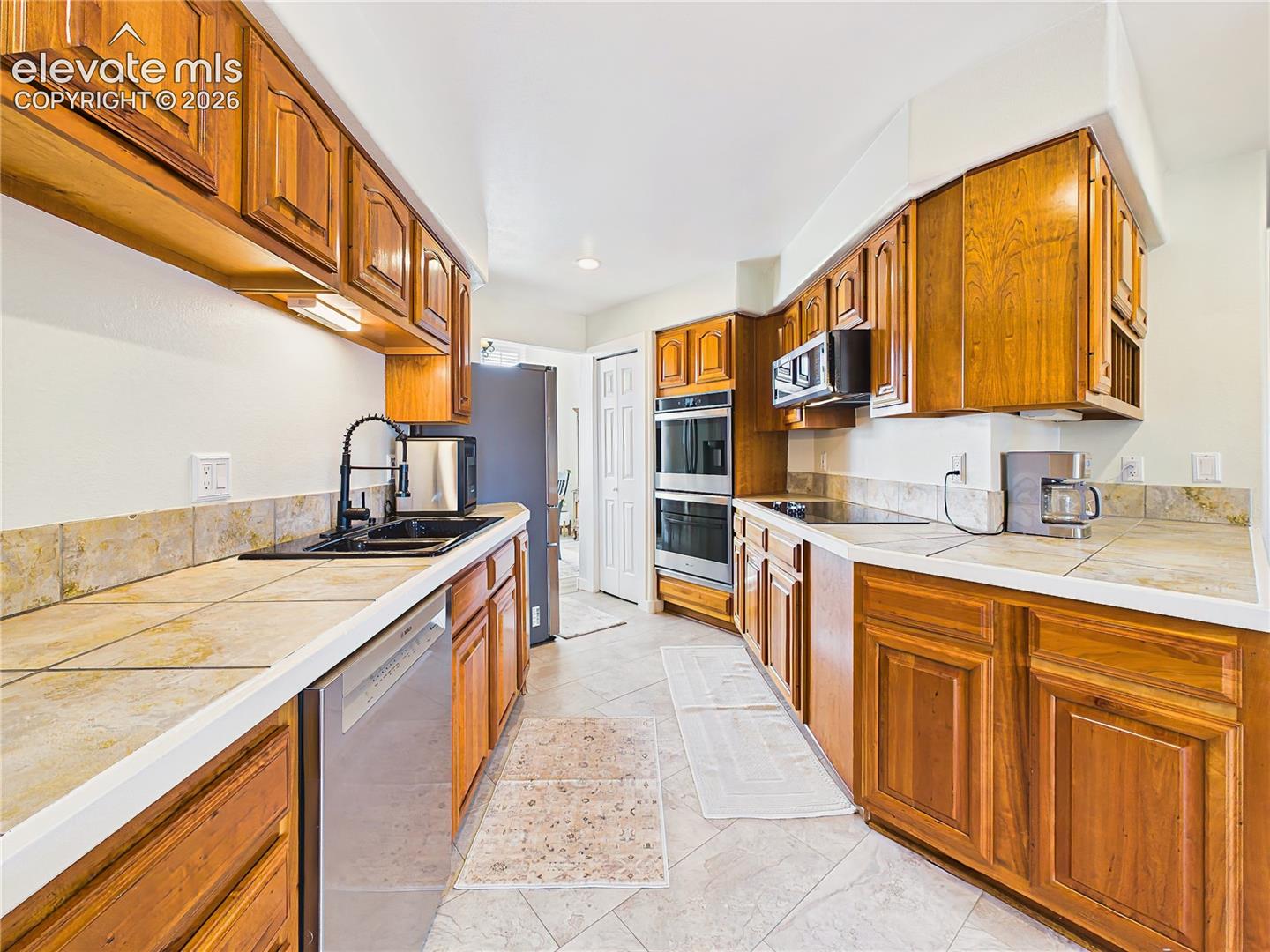Thoughtfully designed galley-style layout offers excellent workflow, with ample prep space, storage, and easy access to adjoining living areas.