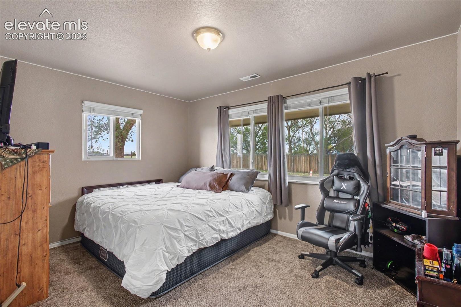 Comfortable secondary bedroom offering a peaceful space for guests, family members, or personal use.