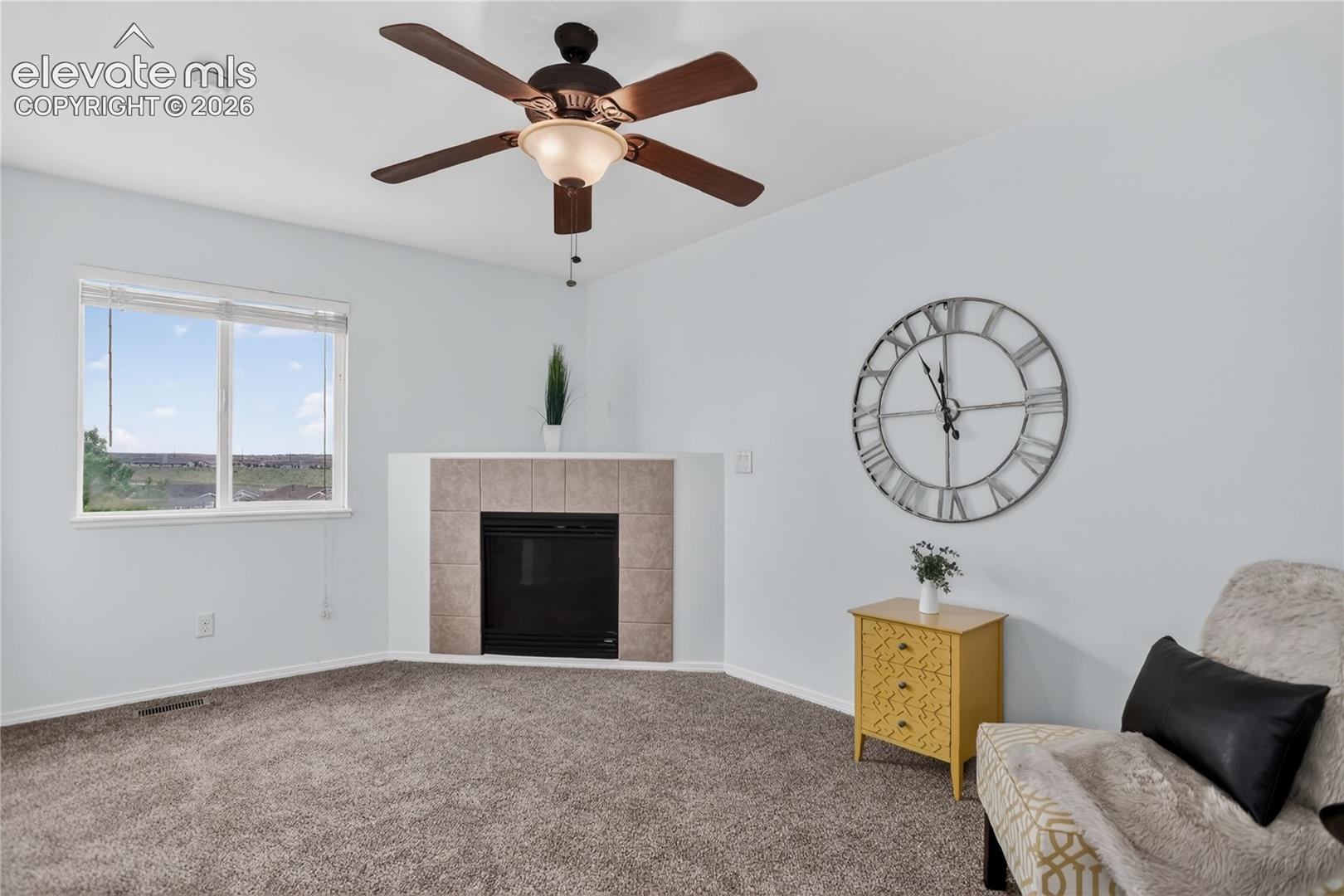 Lofted sitting area off primary suite w/ fireplace