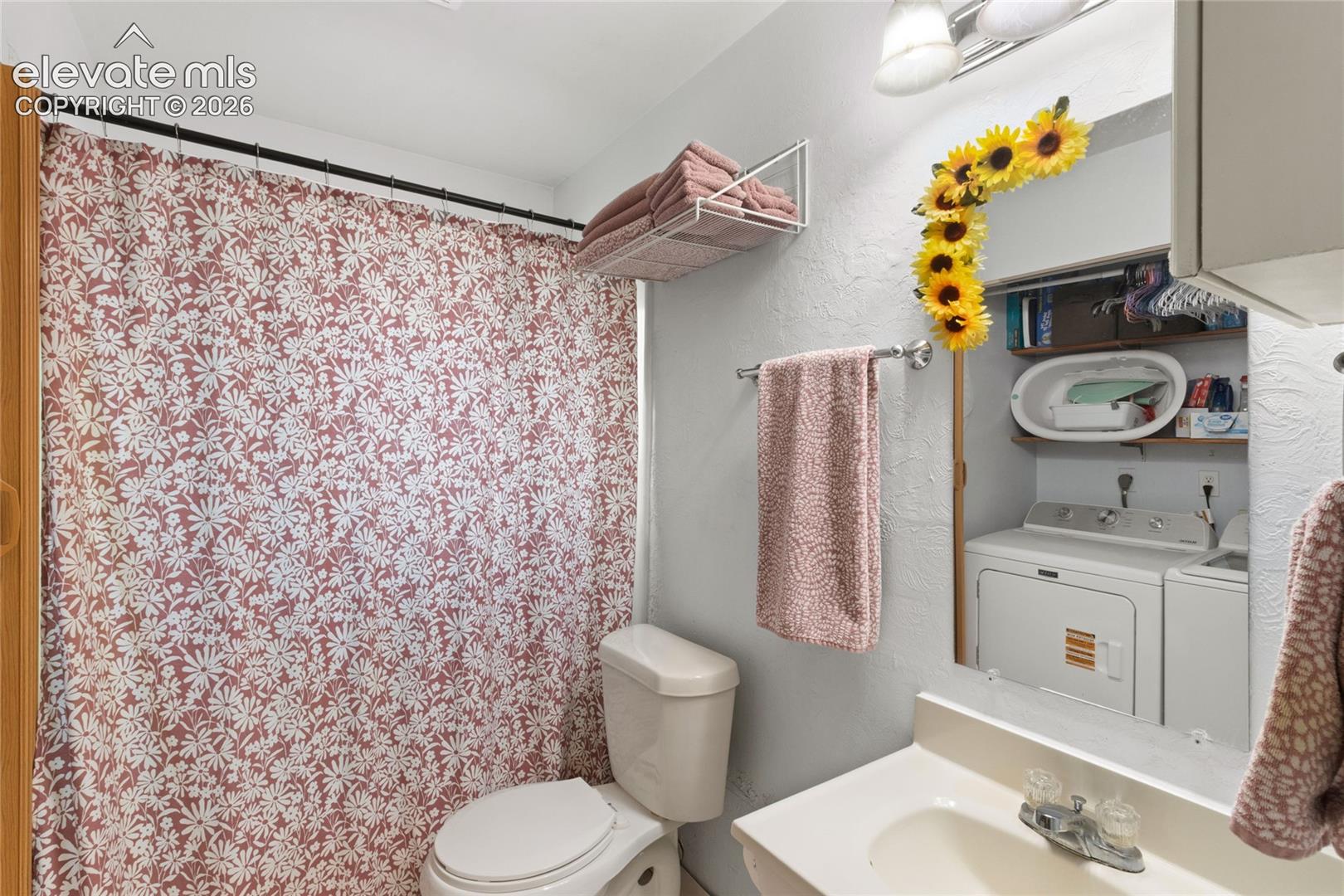 Full bathroom with access to laundry closet