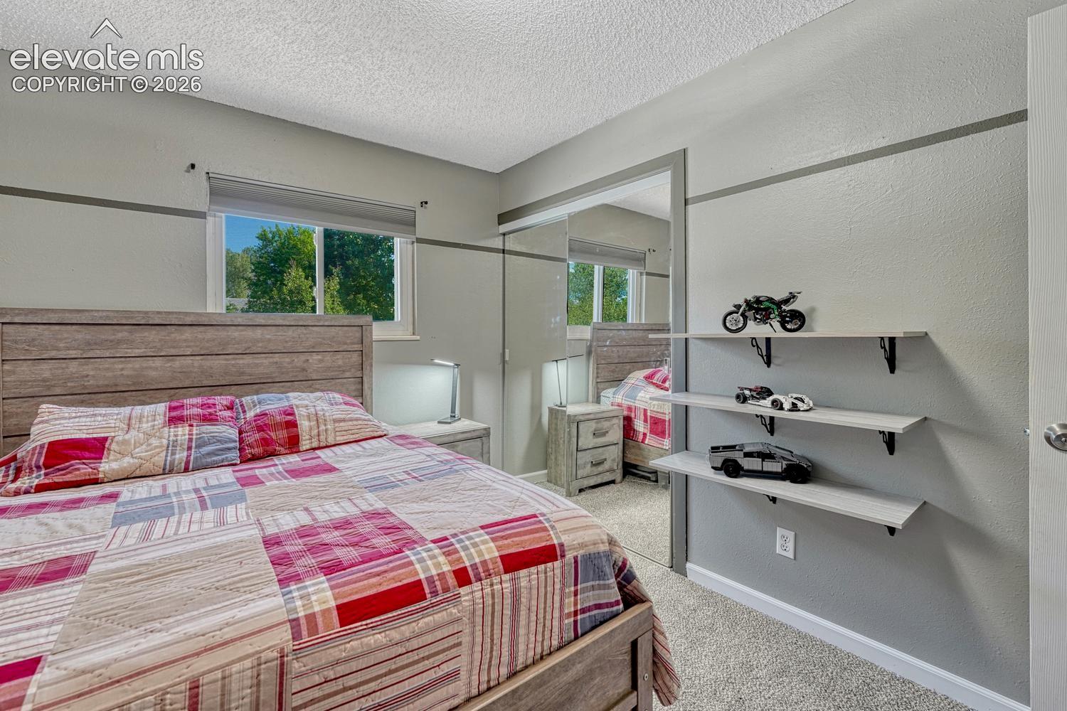 Upper Level Bedroom #2 has new carpet and mirrored wardrobe closet doors.