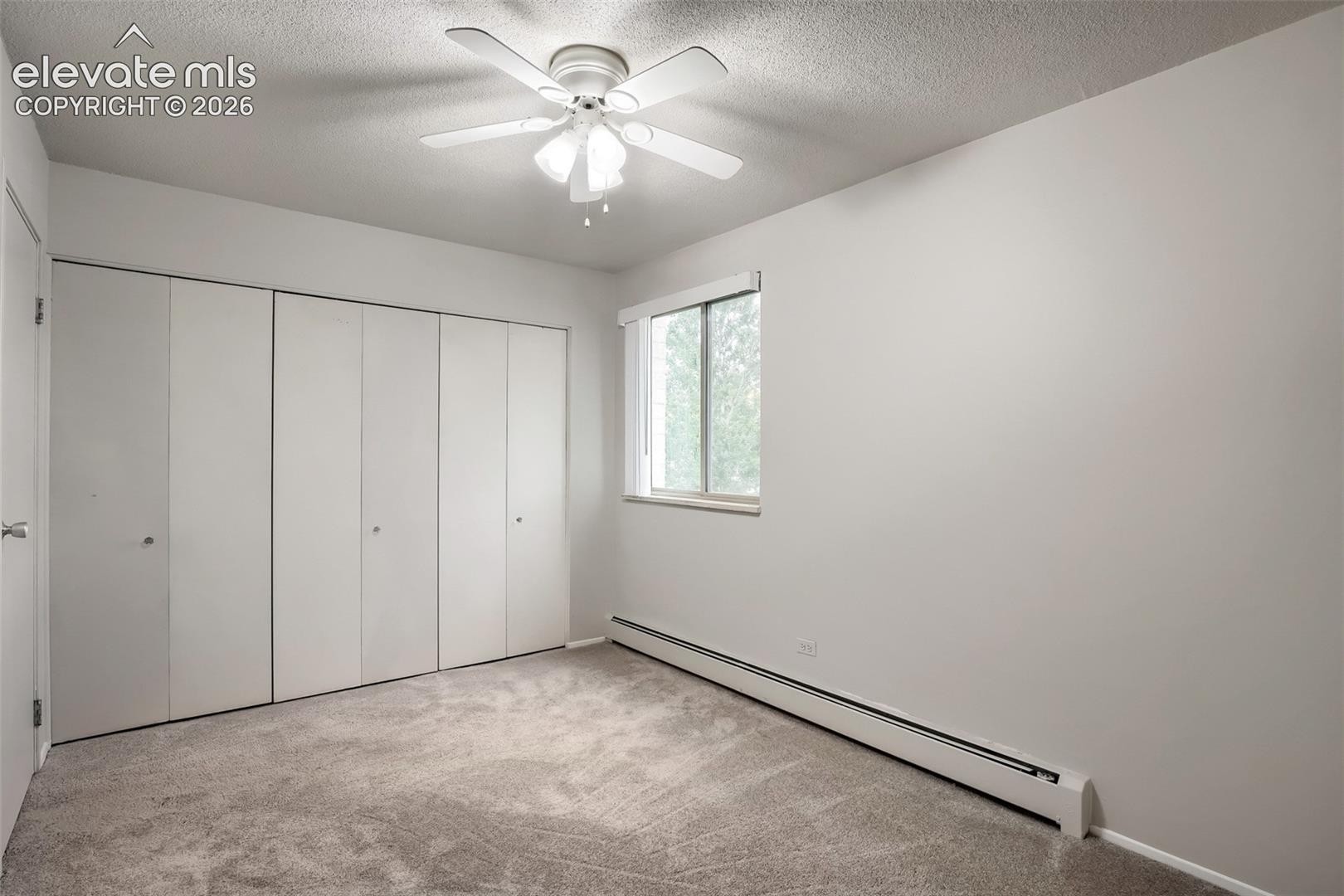 Bedroom featuring a ceiling fan, light gray wall paint, and gray carpet flooring
