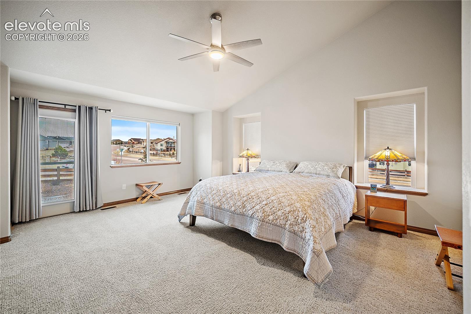 Primary suite, with NEW carpet, vaulted ceilings, 5 piece bath, walk-in closet and walkout. 