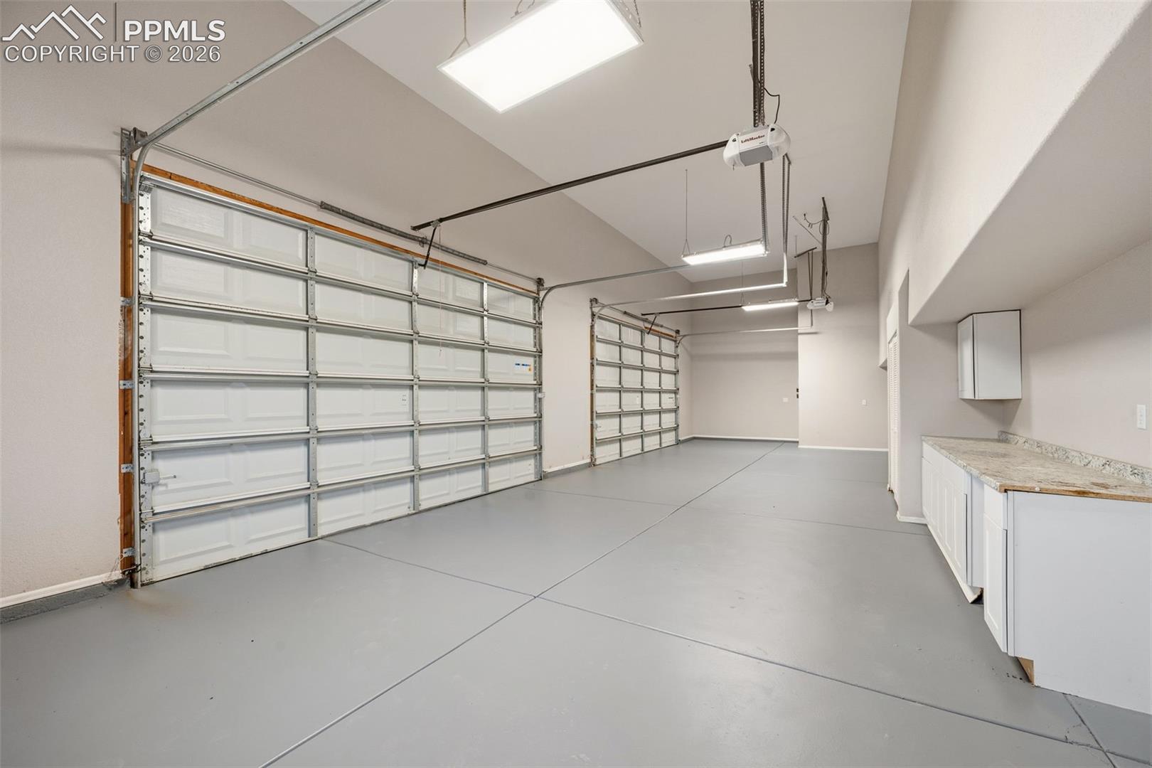 The second garage that is fully finished with drywall and paint 