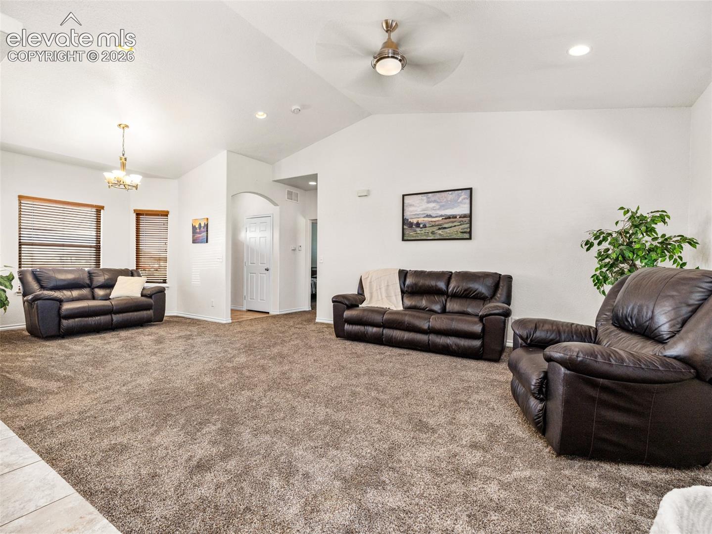 Vaulted ceiling with a ceiling fan, recessed lighting, and wall-to-wall carpeting