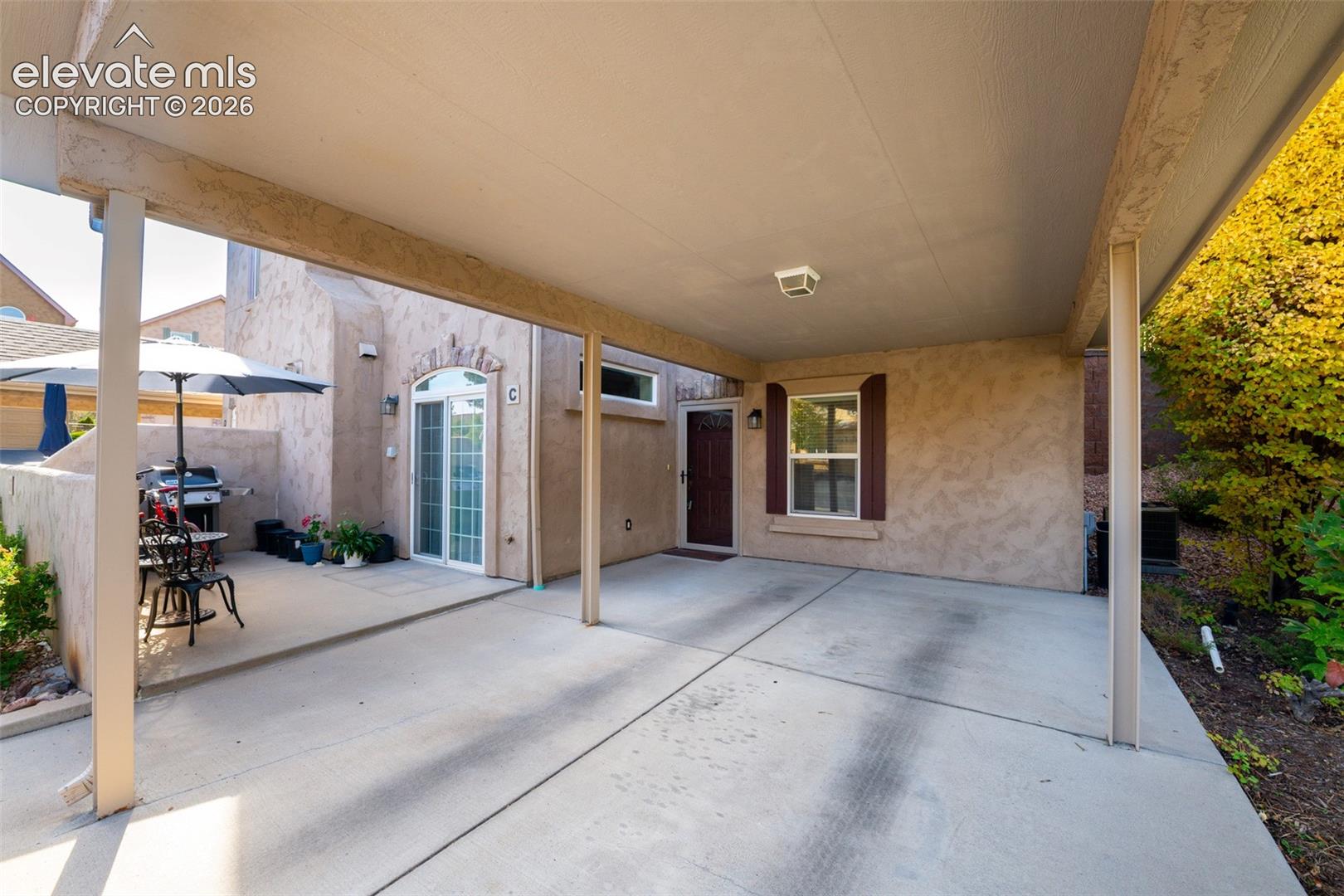Covered carport with concrete flooring