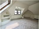 Vaulted ceilings featuring a skylight, dormer window, and integrated shelving