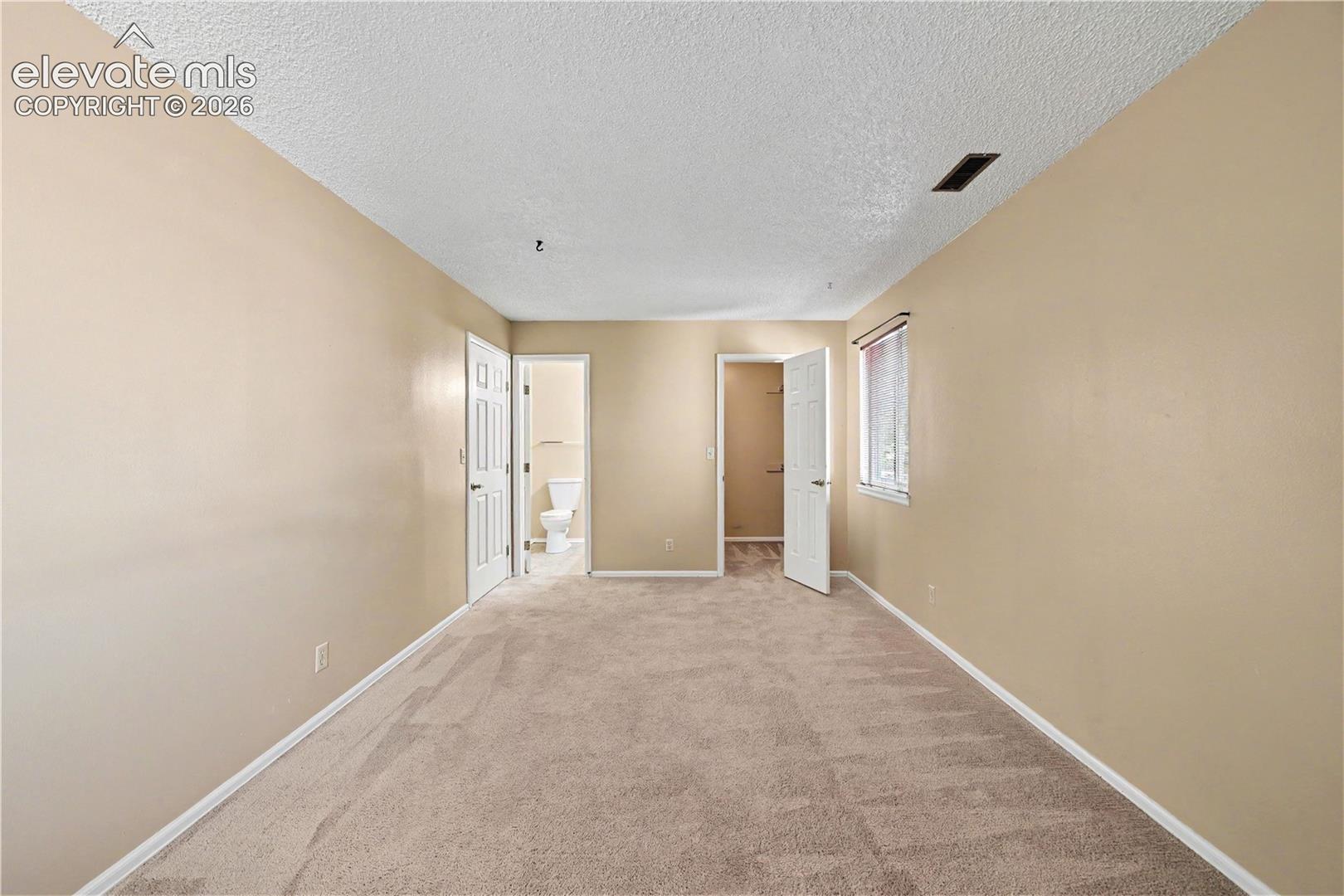 Bedroom with neutral finishes and carpeted floors
