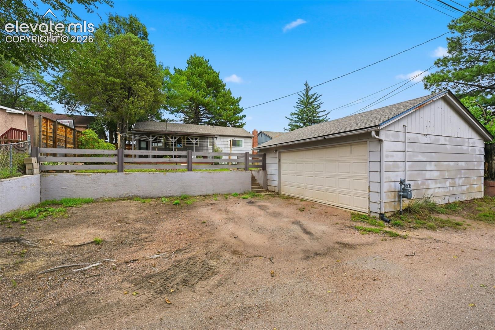 Oversized detached 2-car garage with extra parking spaces
