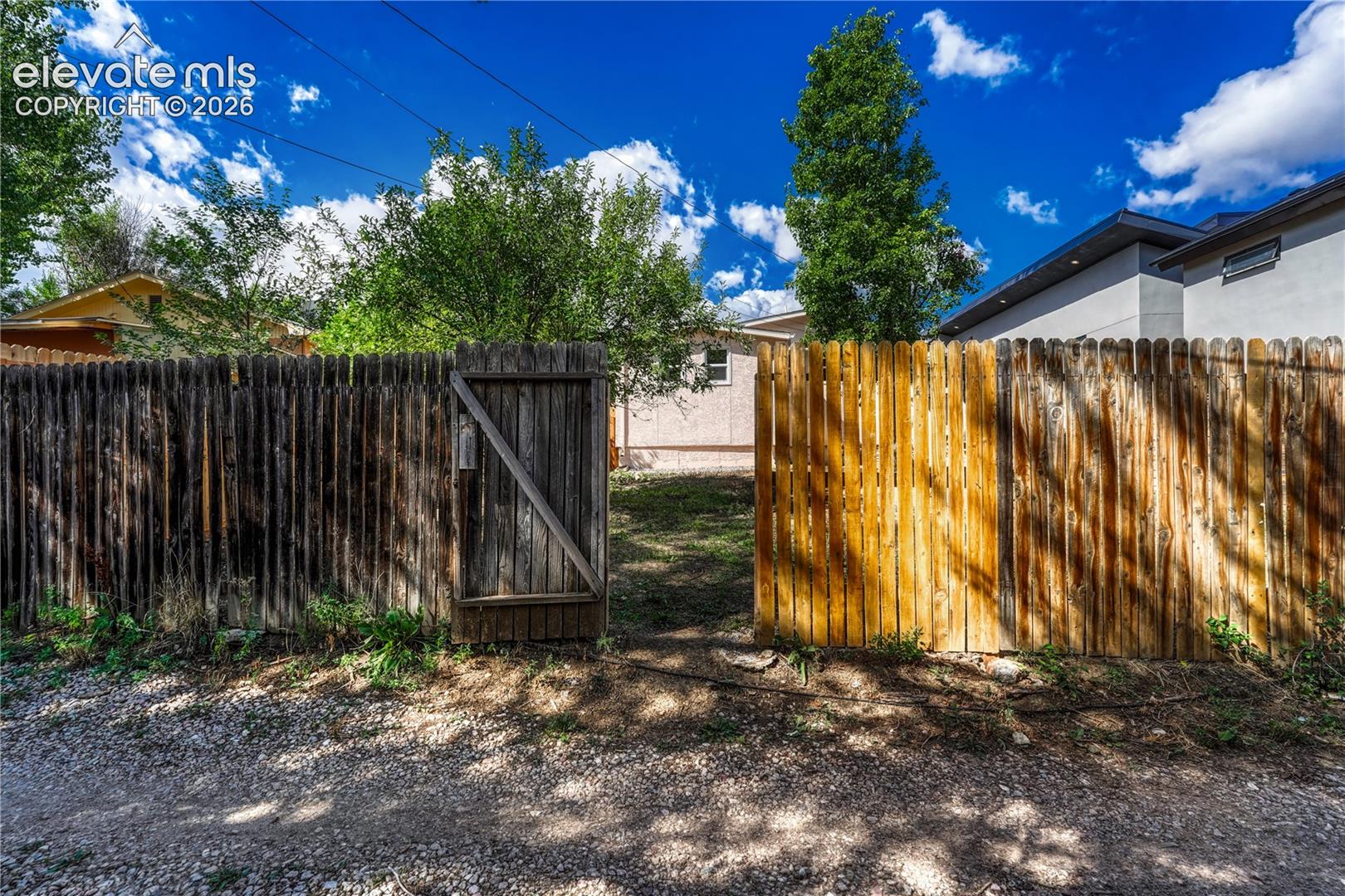 Wood picket fence with a functional gate providing access to the property