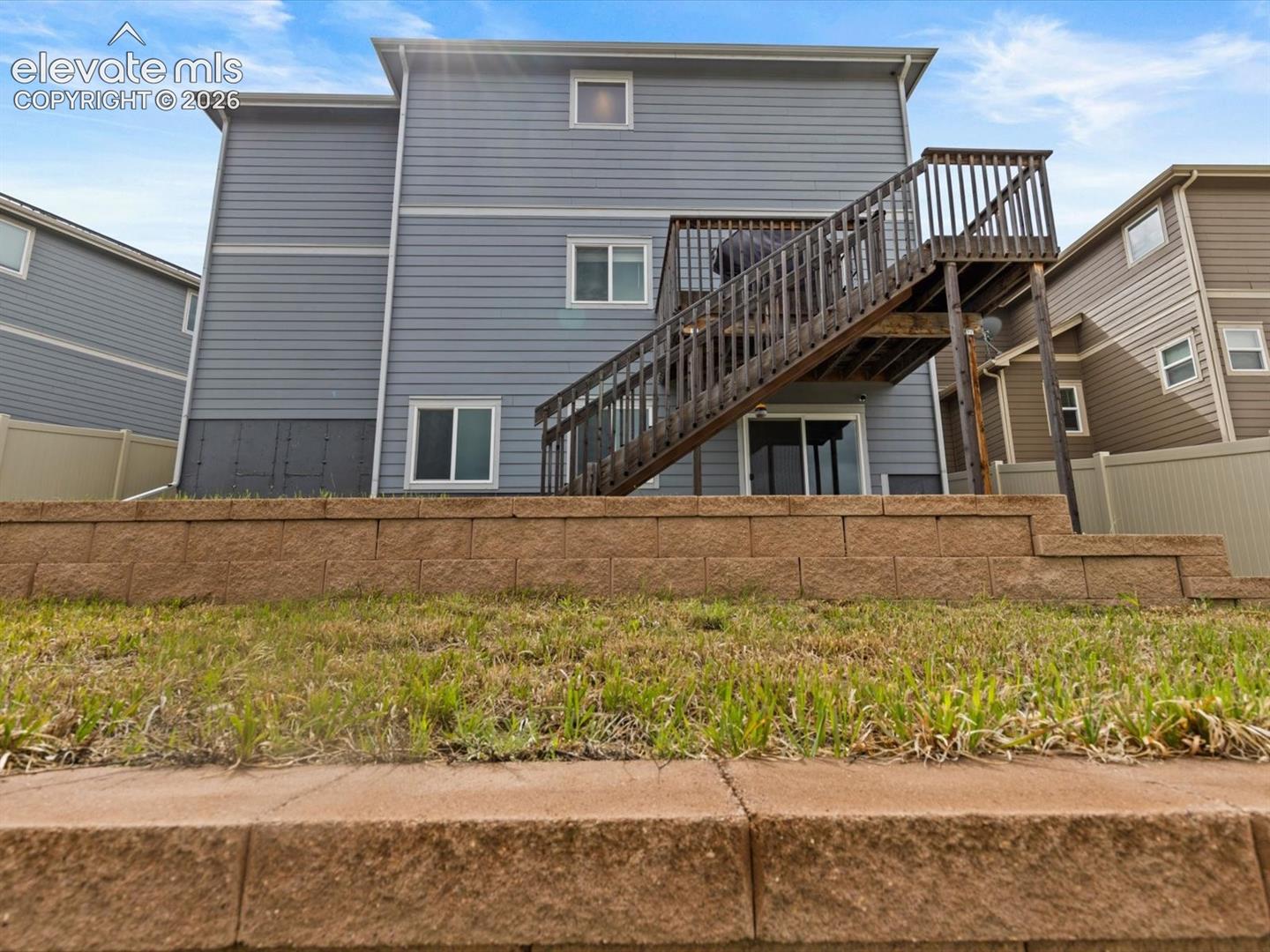 Multi-level retaining wall featuring tiered stone blocks
