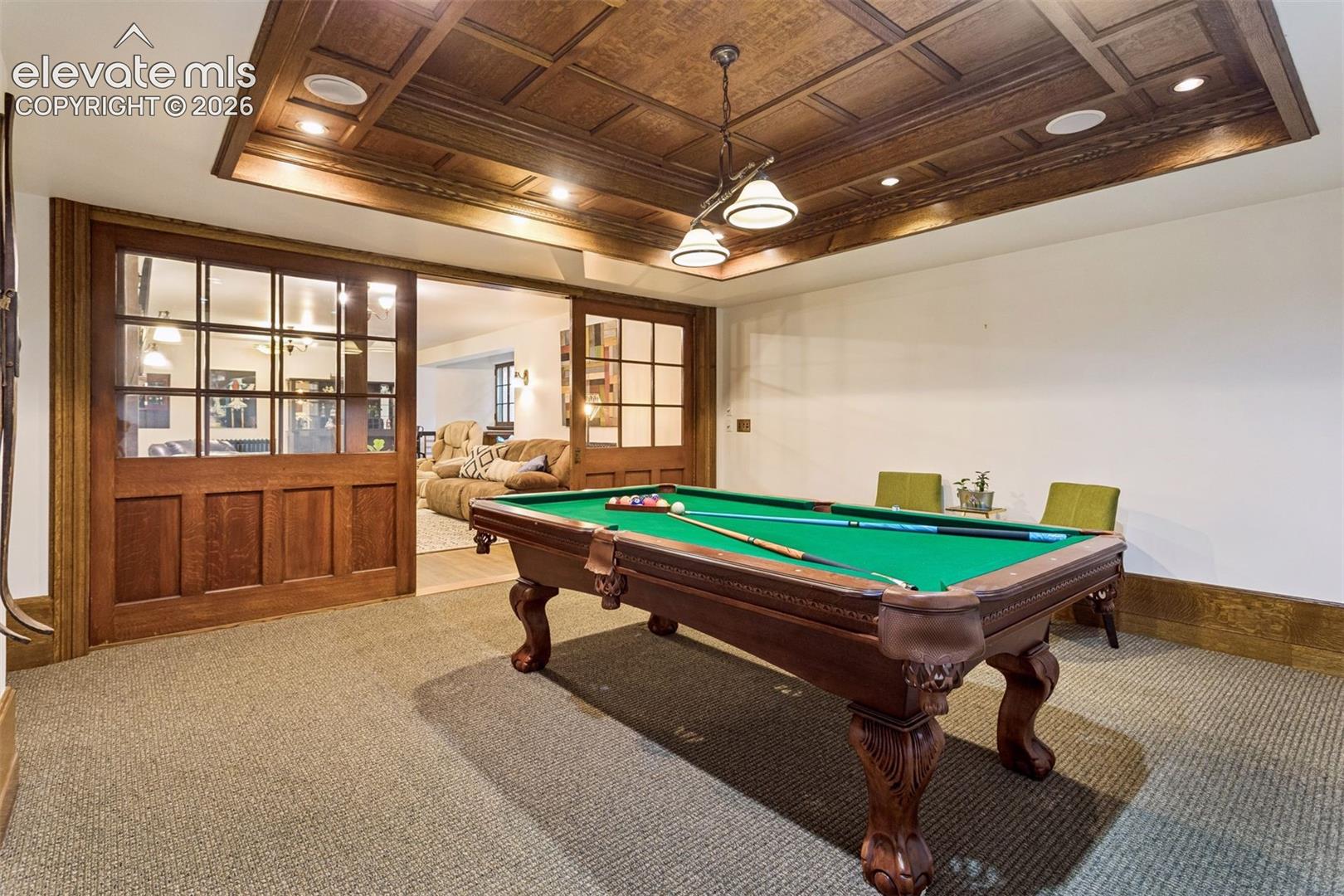 Billiards room with oak paneling and original pocket doors