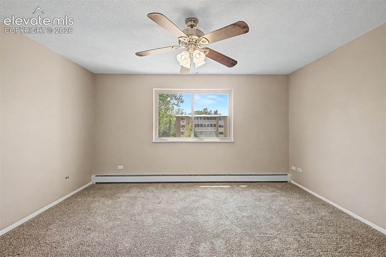 Neutral tone wall paint, textured ceiling, and a ceiling fan with integrated lighting