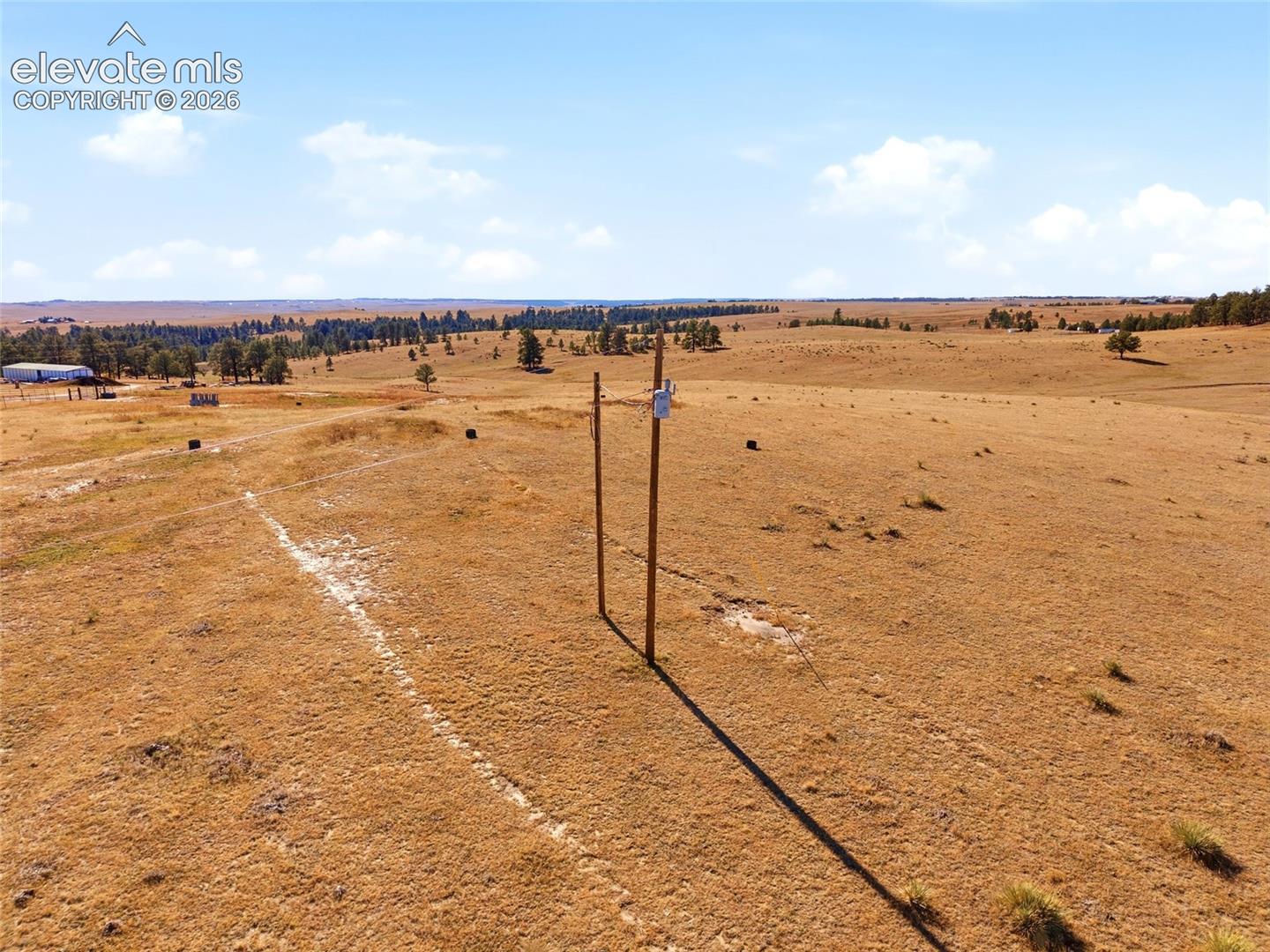 Expansive acreage featuring rolling open terrain and scattered mature trees