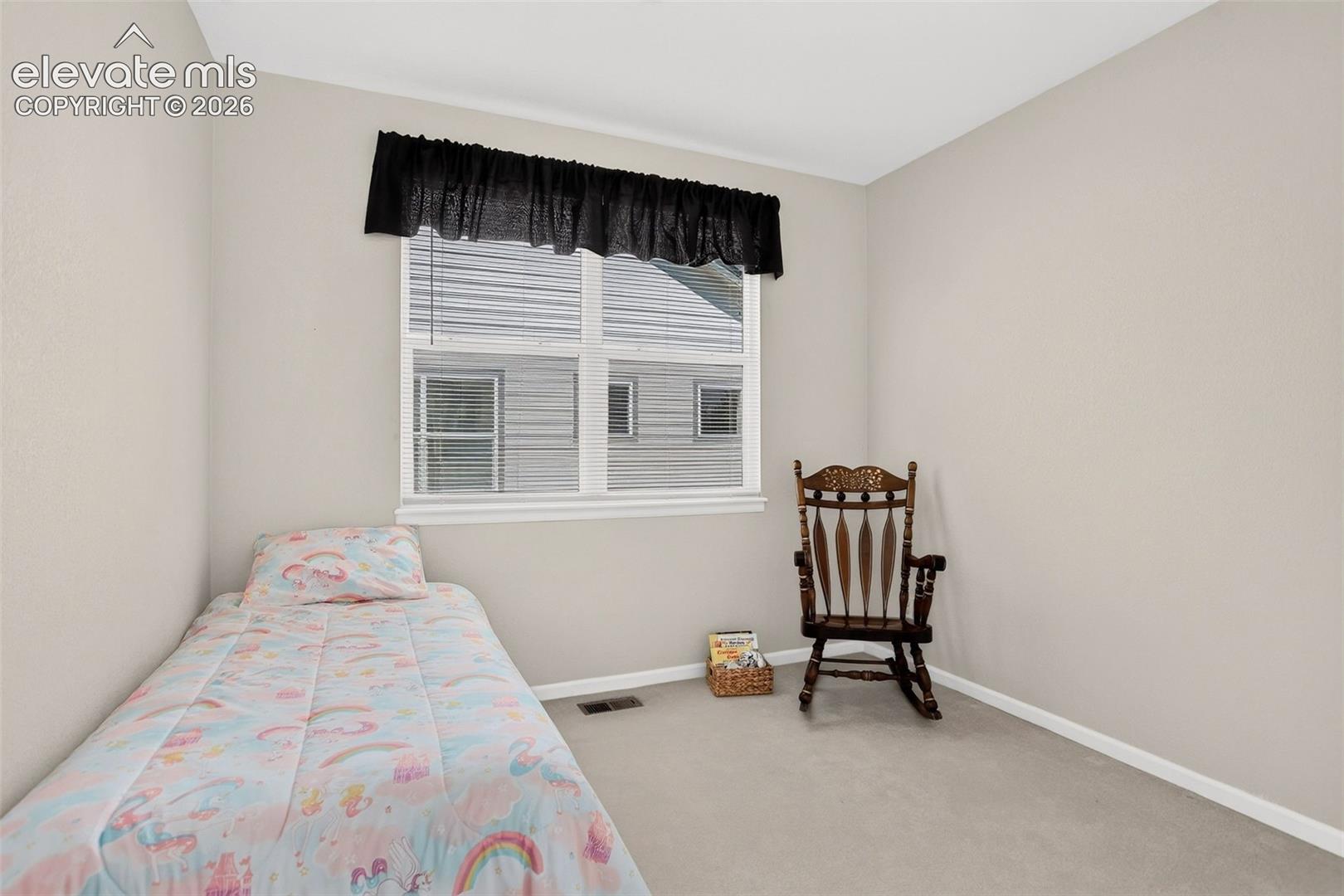 Neutral-toned walls, white window trim, and light gray carpeting
