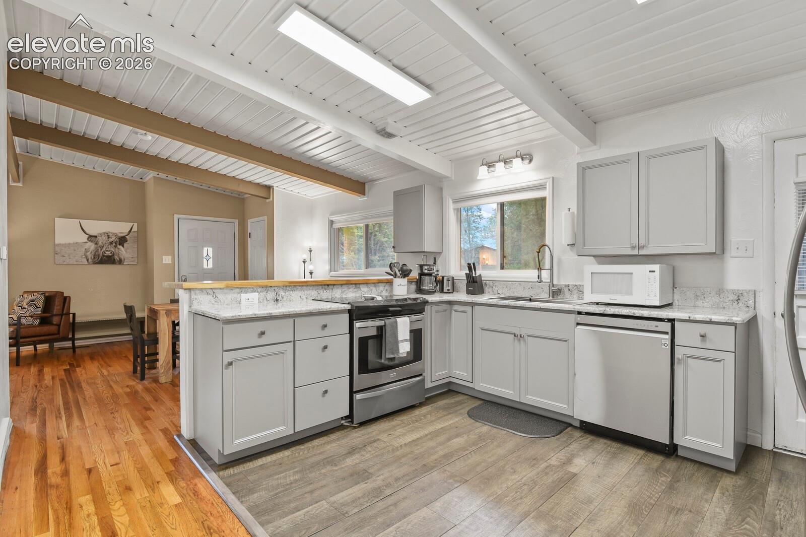 Kitchen from hallway looking toward dining room and entrance.