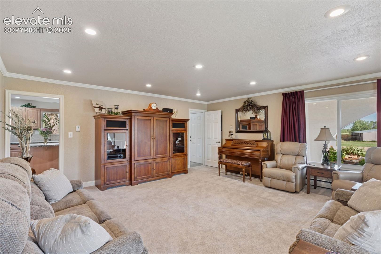 Living Room with access to Kitchen, Mud Room and Powder Room.