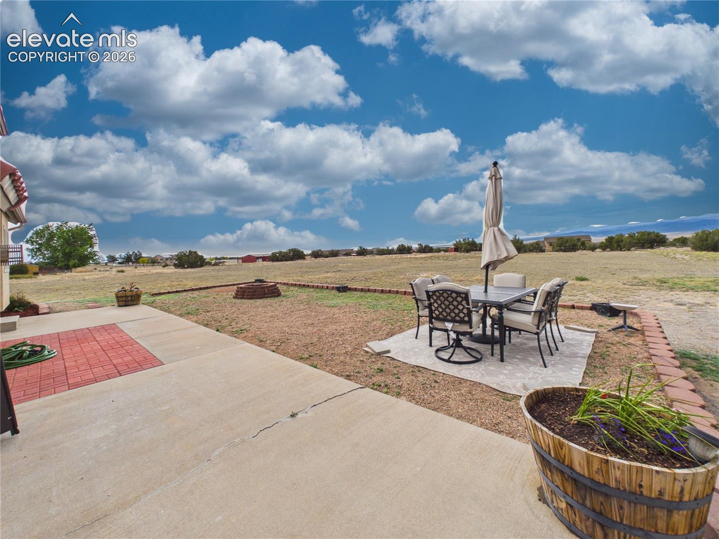 Dedicated seating area offers a peaceful place to unwind while enjoying wide-open views and the natural beauty of the property.