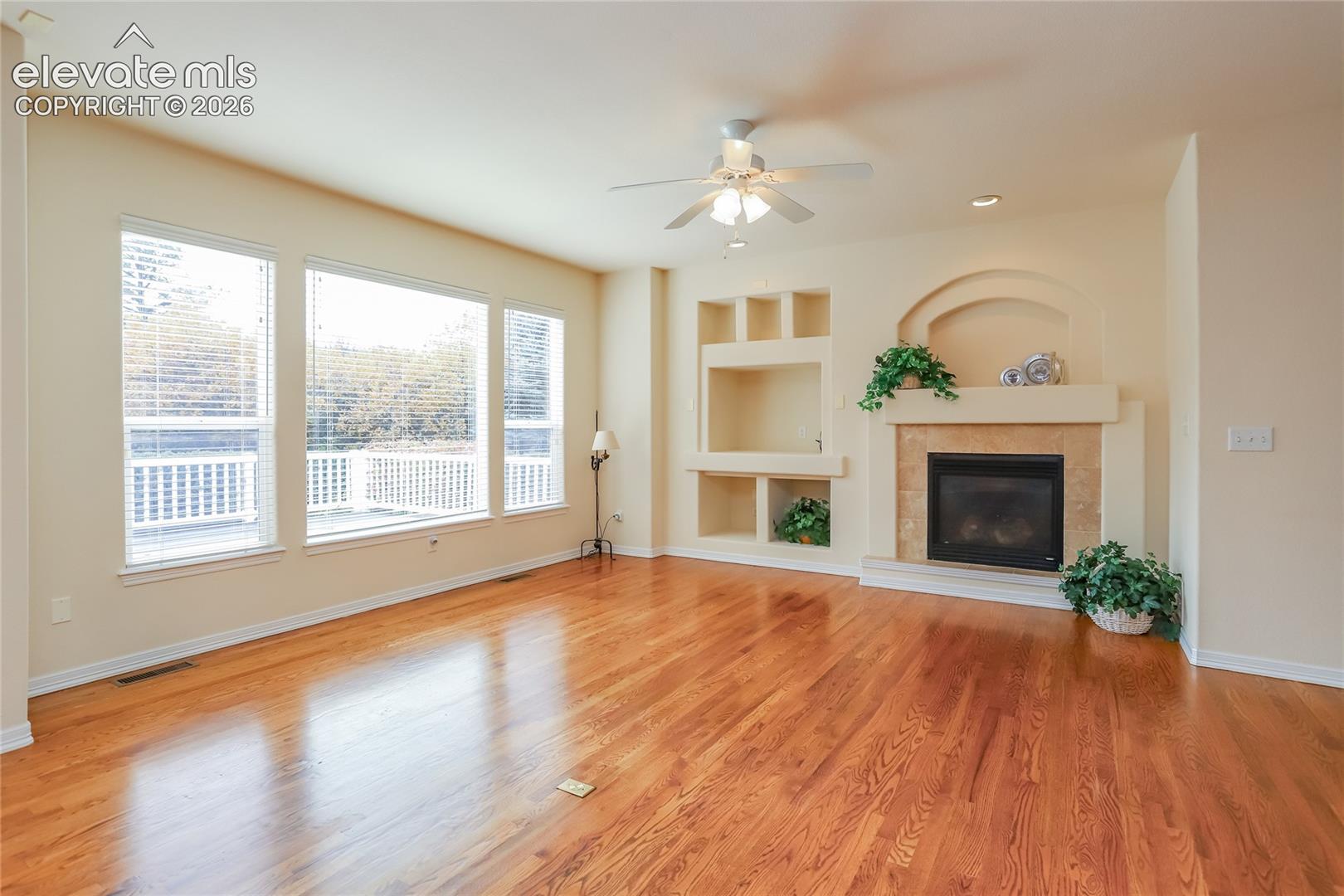 Spacious family room features large windows and a gas fireplace for Colorado winters.