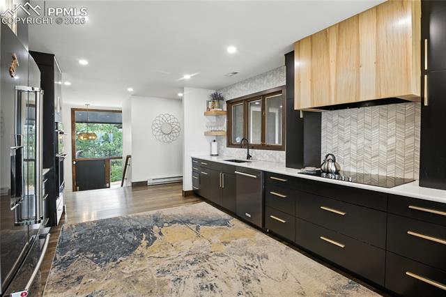 Kitchen featuring open shelves, dark cabinetry, modern cabinets, backsplash, and recessed lighting