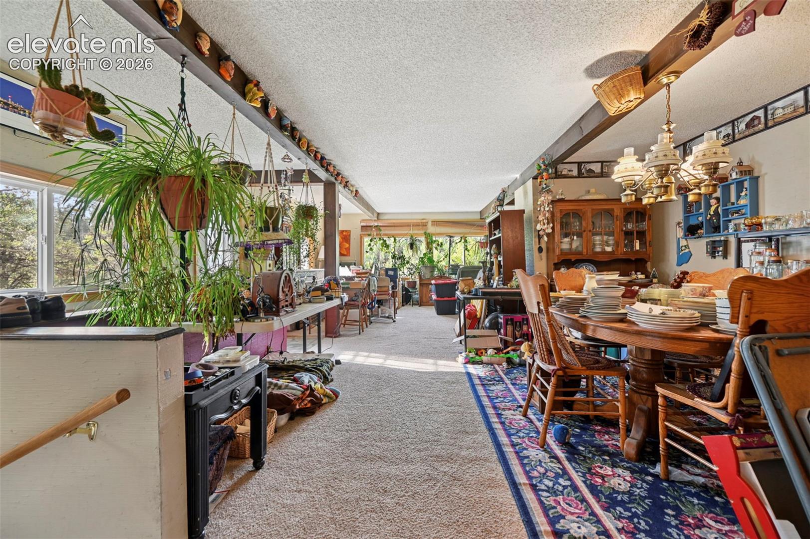 Exposed ceiling beams, recessed windows, and wood-finish flooring