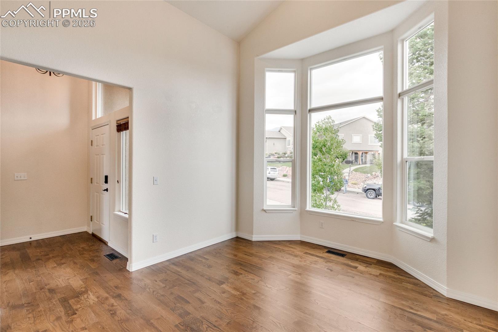 Living room off of entry featuring soaring ceilings and extensive natural light through expansive windows.  