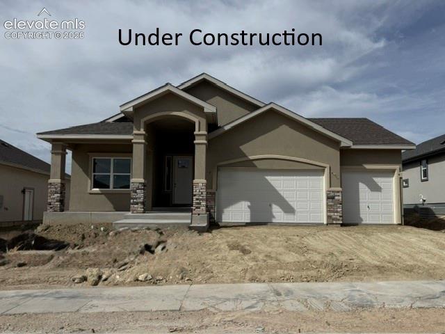 This beautifully designed 4-bedroom, 3 bath ranch style home with a finished basement offers an open, airy floor plan with vaulted ceilings and a welcoming fireplace anchoring the main living space.  The gourmet kitchen is ideal for both everyday living and entertaining, featuring granite countertops, a dedicated buffet, and seamless flow into the dining and living areas.  Durable LVP flooring extends throughout the main living area and all the bathrooms, combining style with easy maintenance.  The exterior showcases classic stucco, while the impressive 4 car tandem garage provides exceptional storage and flexibility.  Thoughtfully finished with quartz counter tops in kitchen and granite throughout all bathrooms, this home blends comfort, function and timeless design.  Virtual tour and still photos are of previous home built of the same plan; colors and specification may vary and are not exactly as seen in virtual tour or still photos.