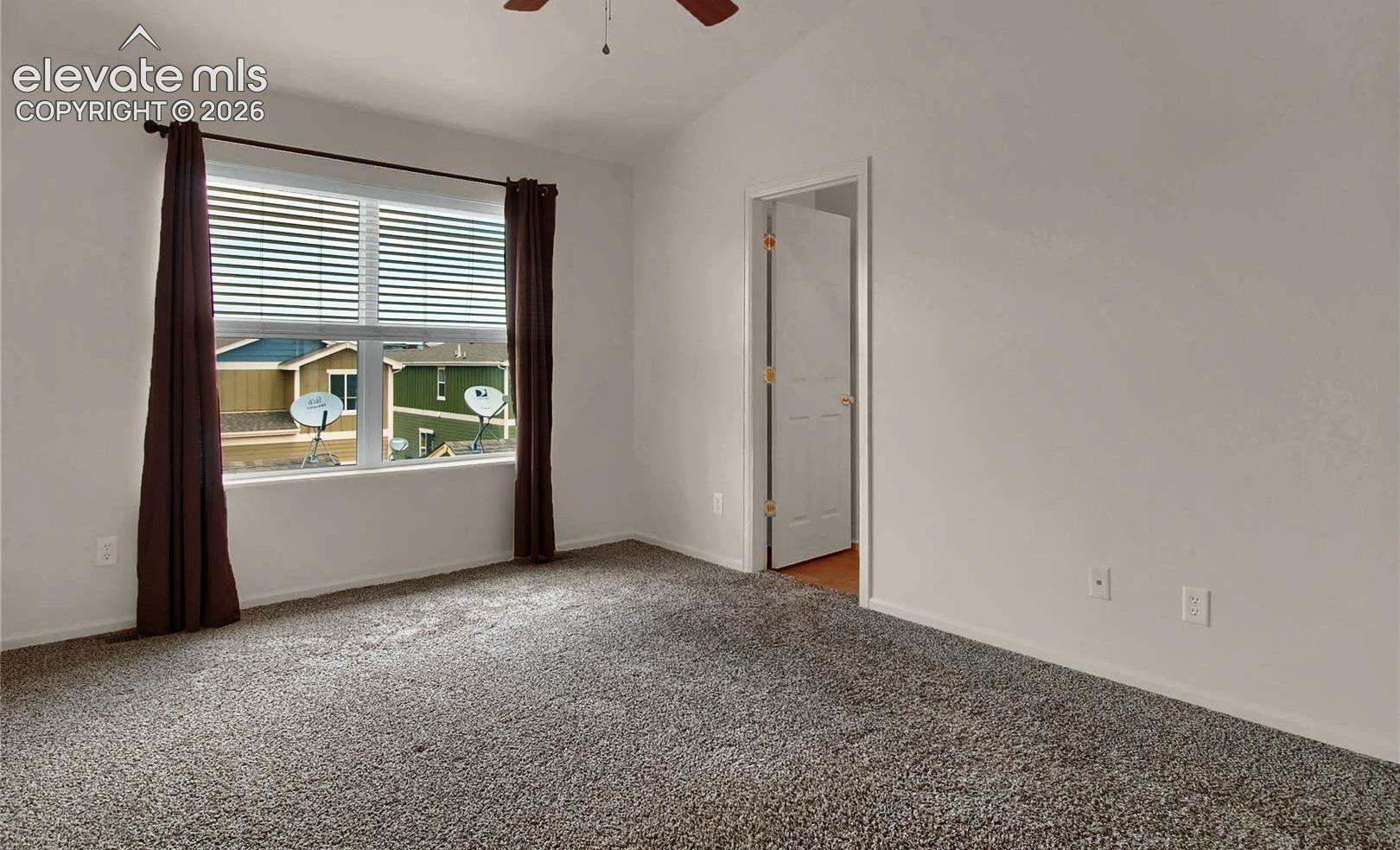 When vacant primary bedroom angle towards bathroom entrance