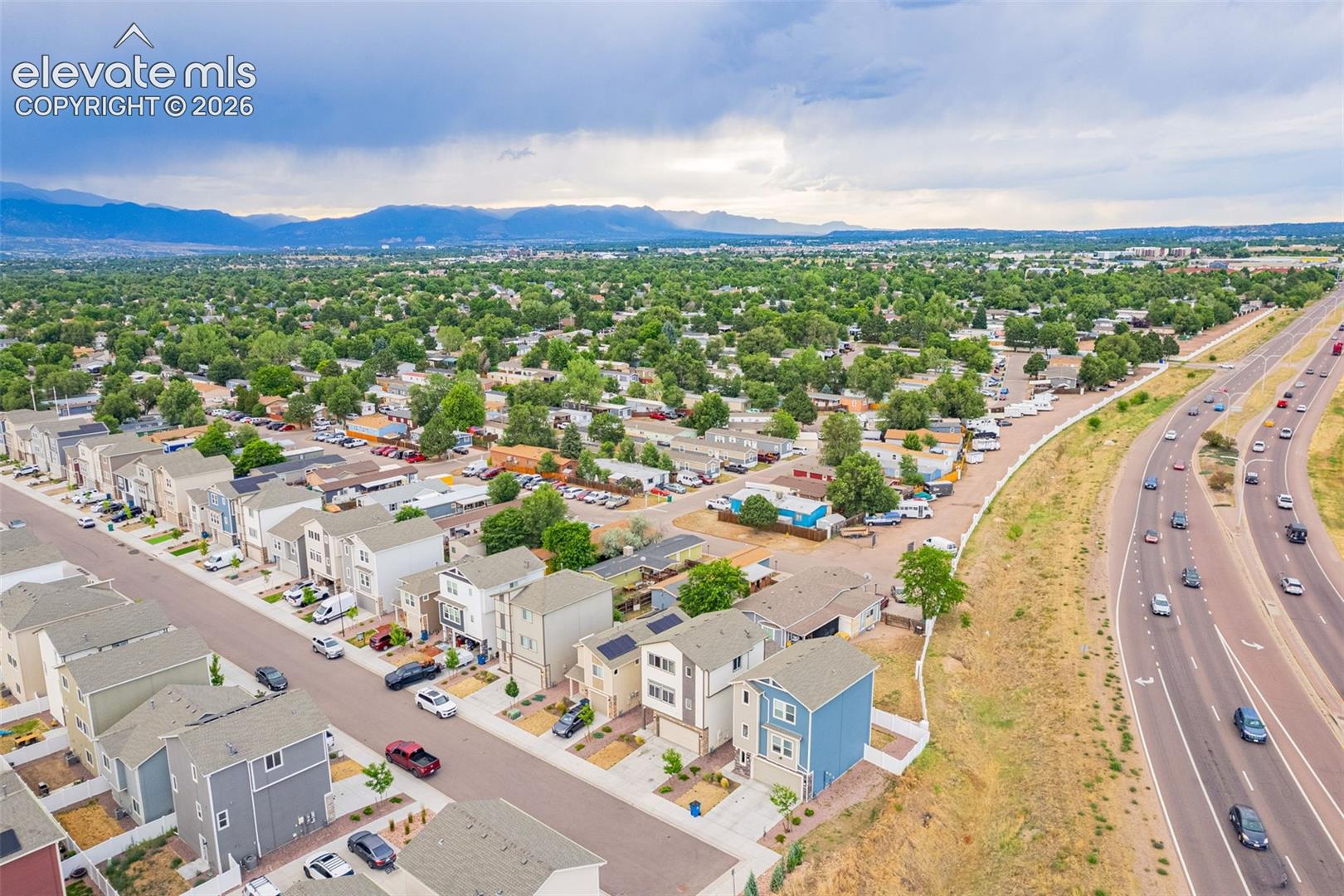 Aerial perspective showcasing a modern residential development with a mountain backdrop