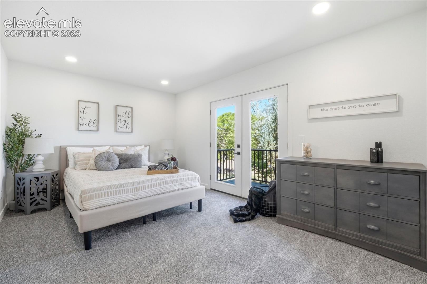 Bedroom featuring a private balcony through double French doors, recessed lighting, wall-to-wall carpeting, and white painted walls