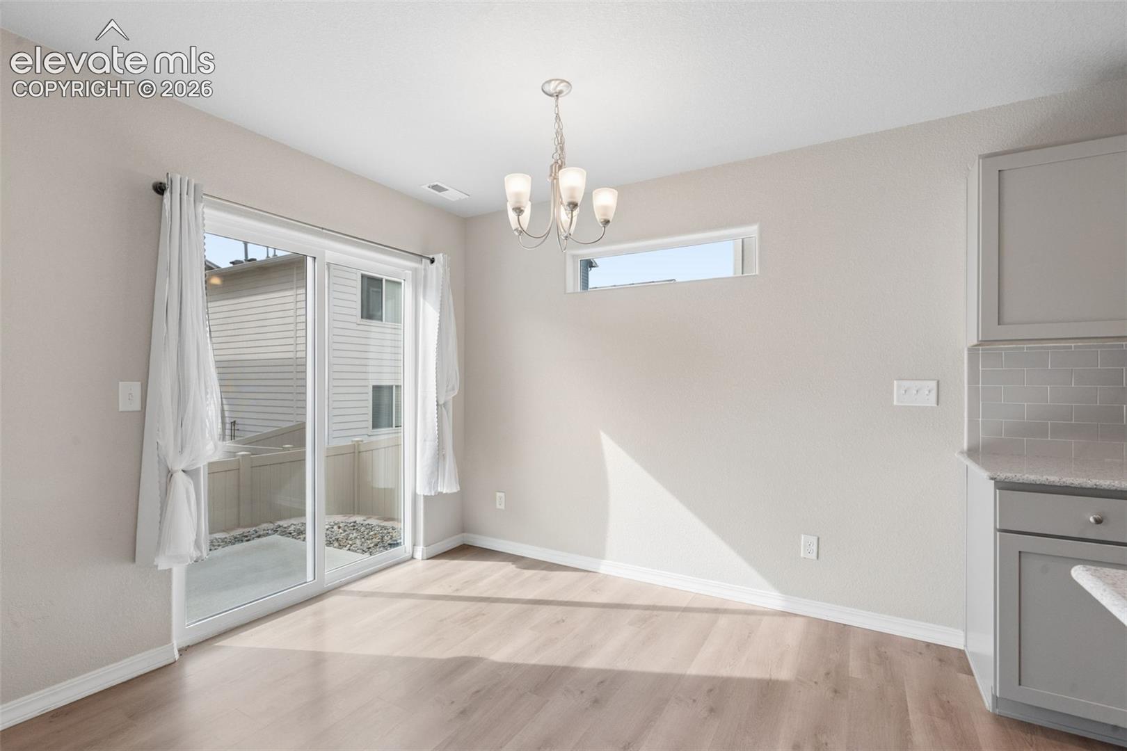 The Dining Area is conveniently near the Kitchen and offers access to the home's backyard!