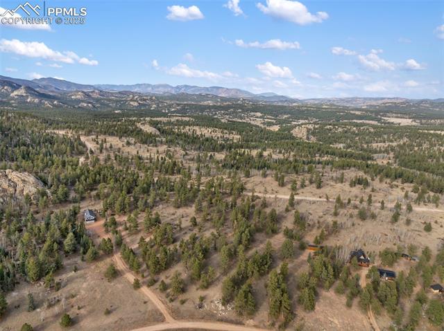 Aerial view of property's location with a mountainous background