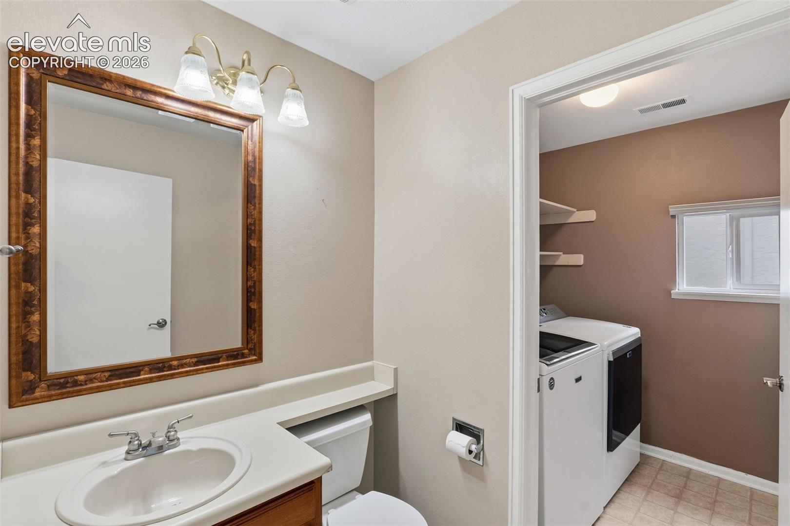 Bathroom vanity with a white countertop and a framed mirror