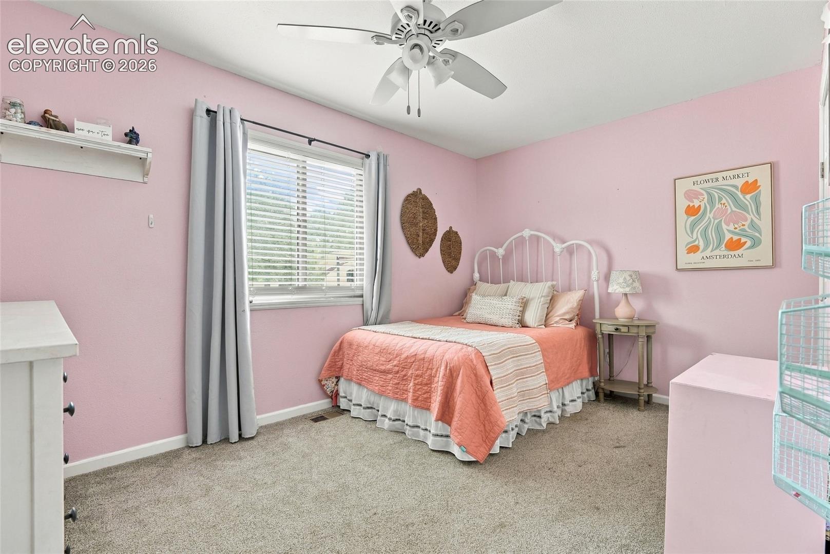 Recessed window with blinds, ceiling fan with integrated lighting, and neutral carpet flooring
