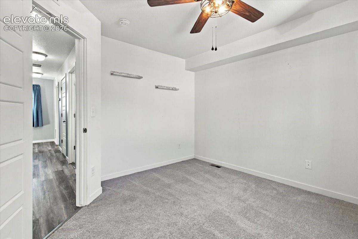 Recessed lighting, wood-finish flooring, and a ceiling fan with integrated lighting