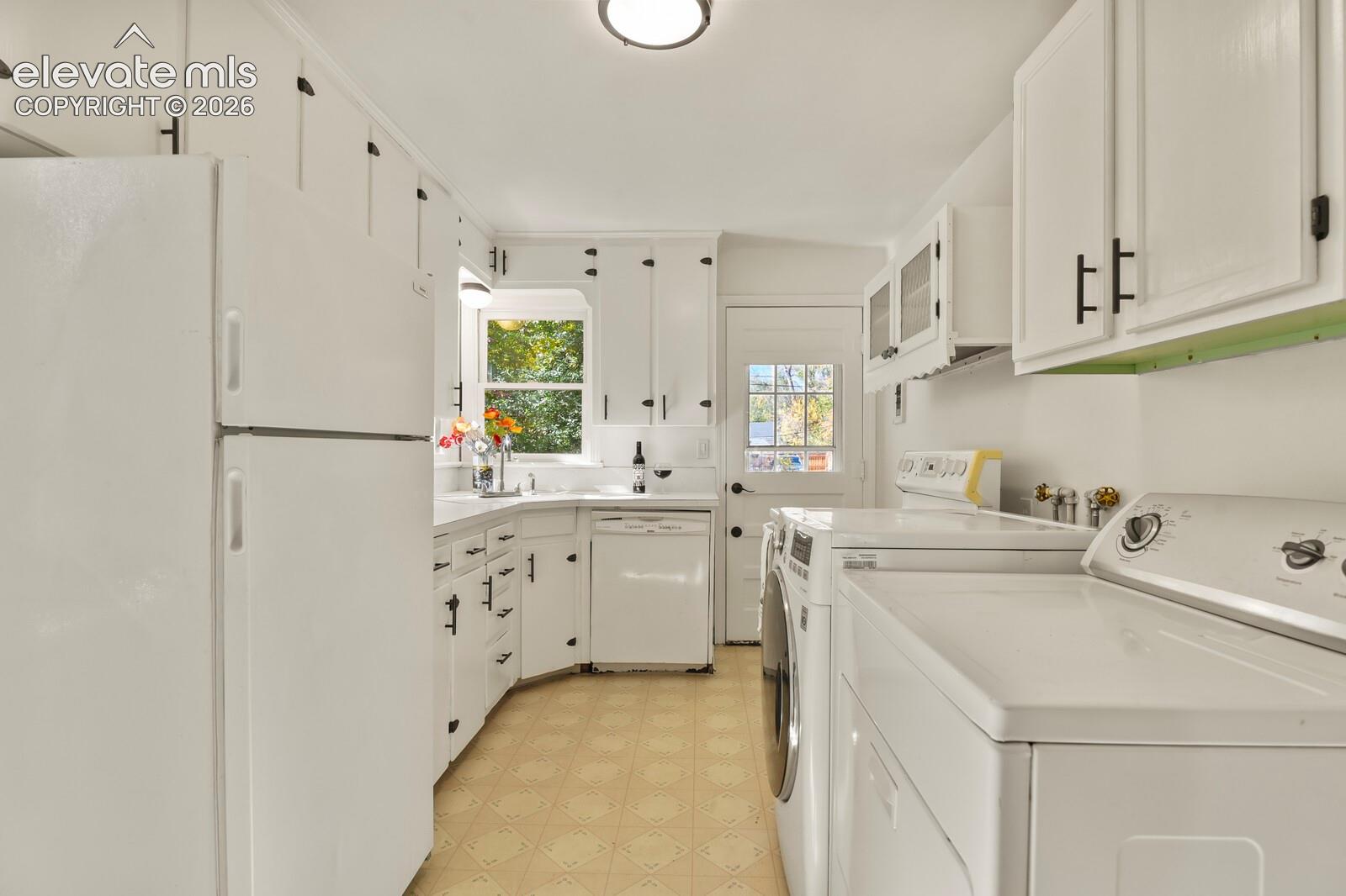 Kitchen featuring white cabinetry with matte black hardware