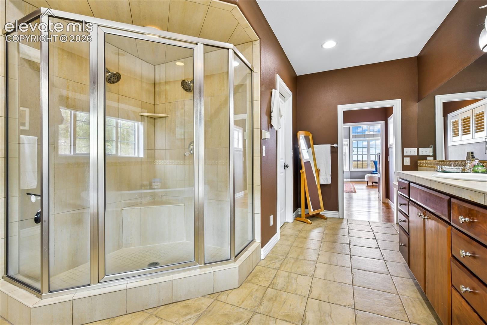 Walk-in shower, walk-in closet, and breezeway between Primary and Primary Bath