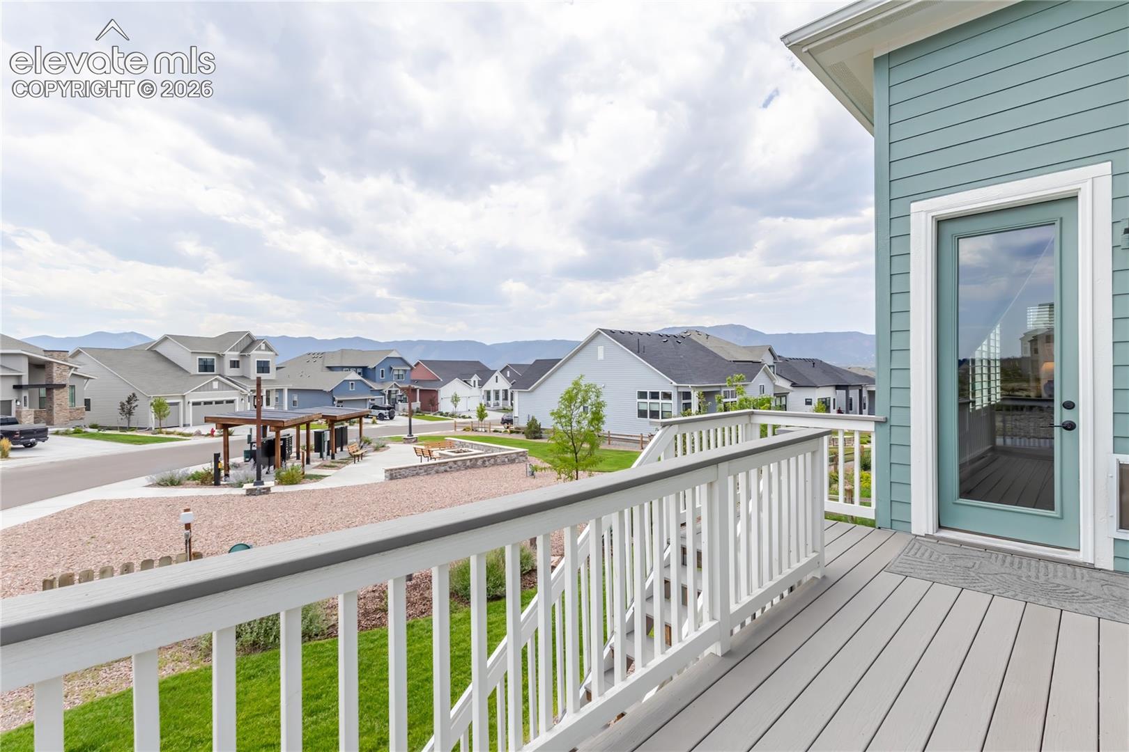 Composite decking with white railing and full glass door