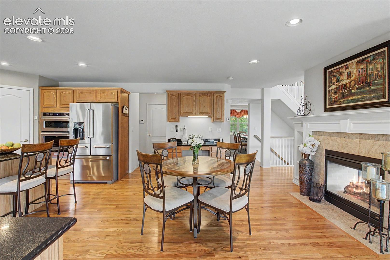 Warm and Inviting Breakfast Nook with Dual Sided Gas Fireplace Boasting Built in Shelves!