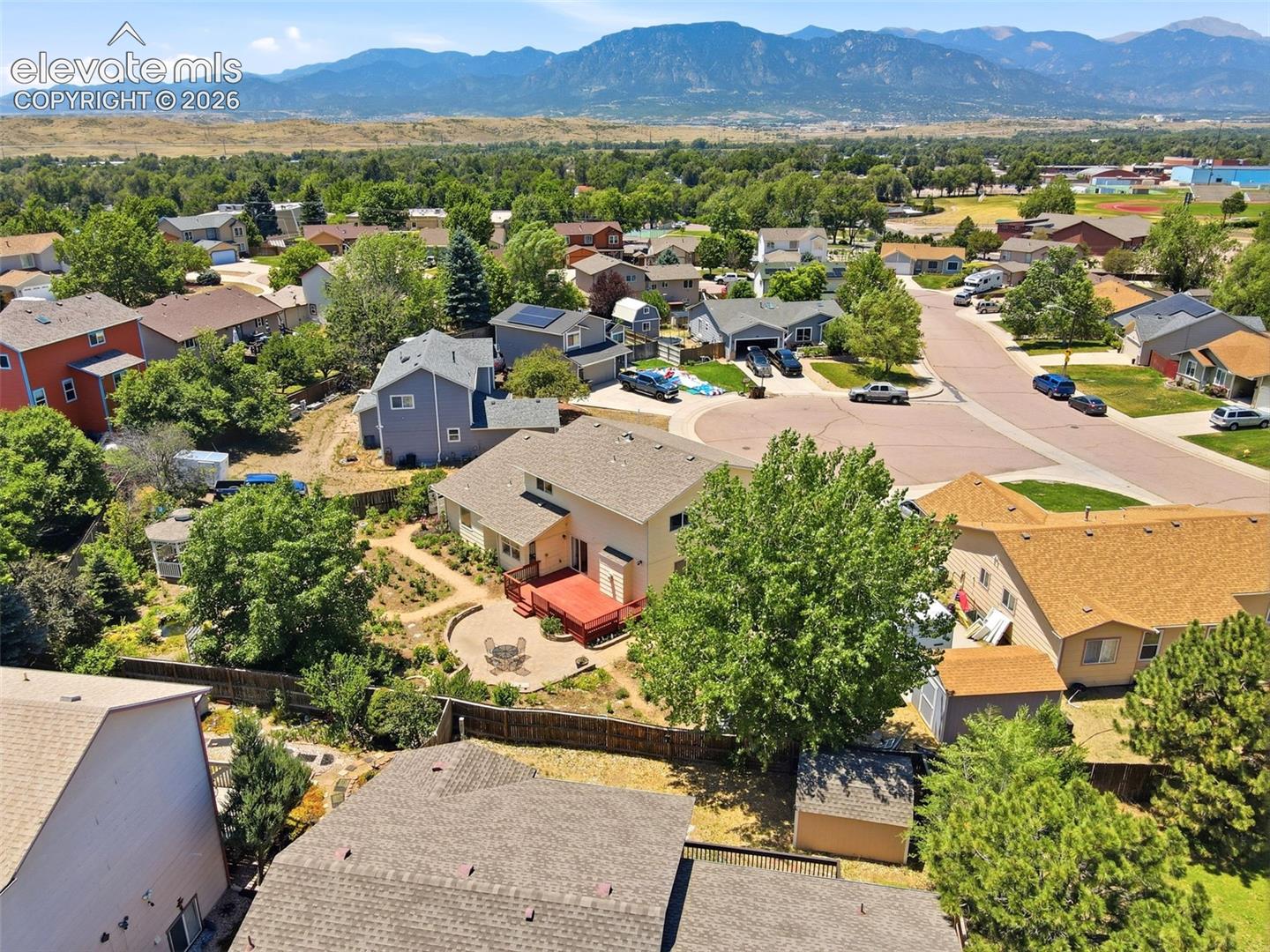 Aerial perspective showcasing a residential neighborhood with surrounding natural landscapes