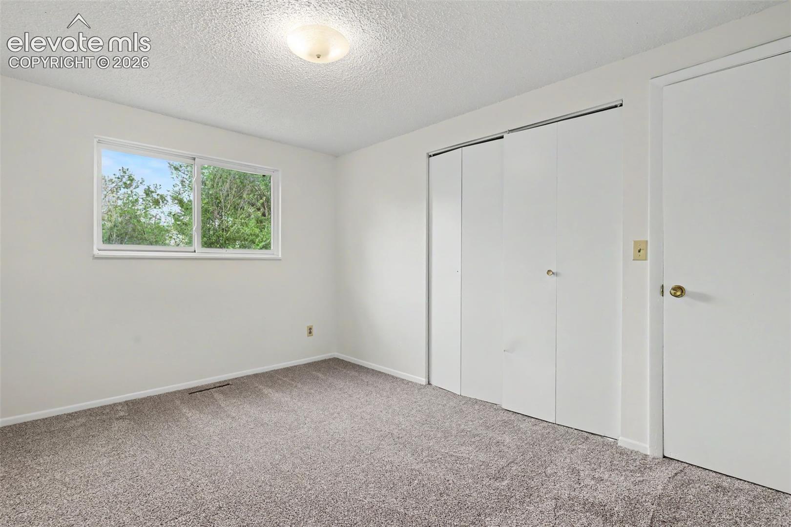 Comfortable secondary bedroom with natural light.