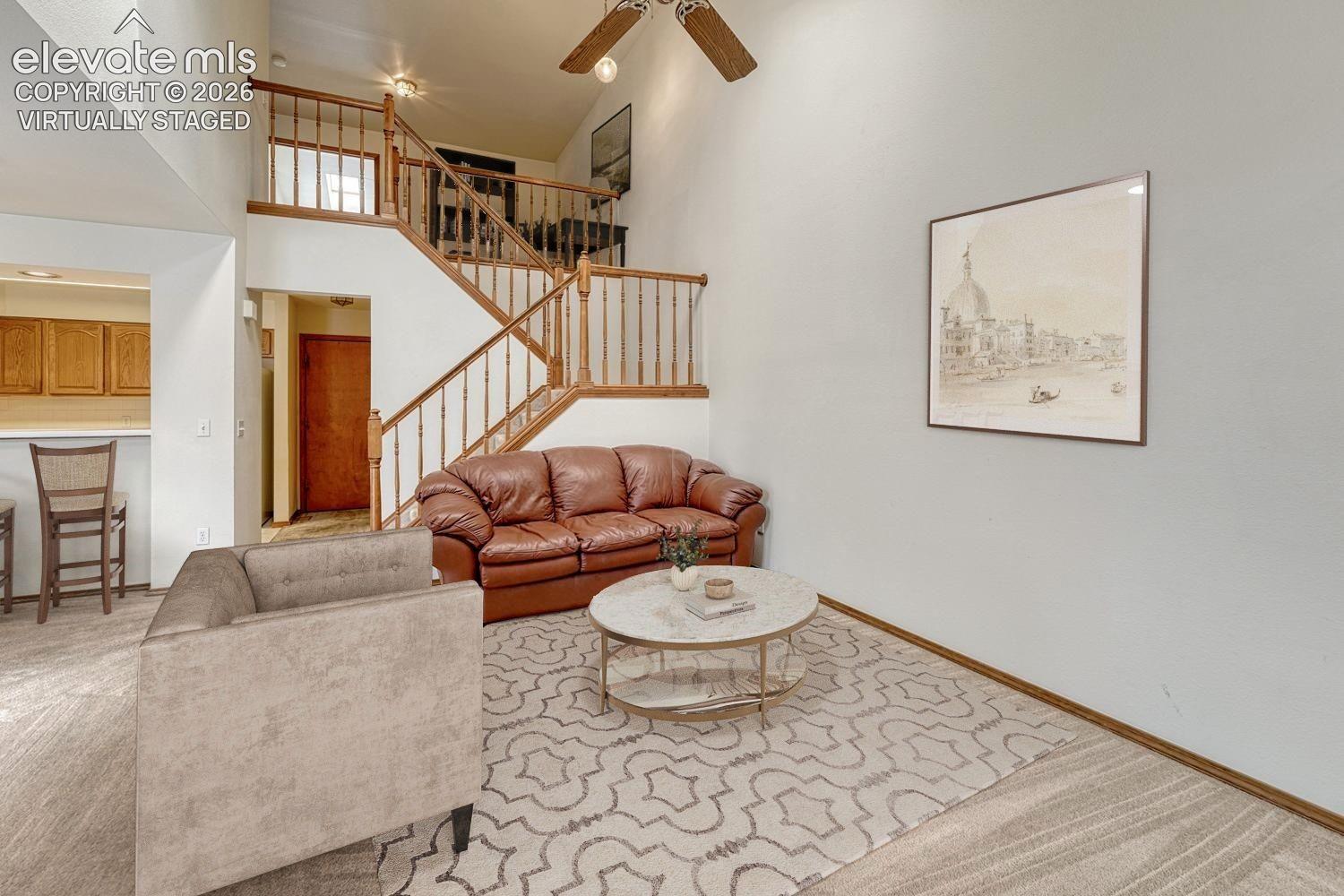 Vaulted ceiling with skylights illuminate the living room. Virtually staged.